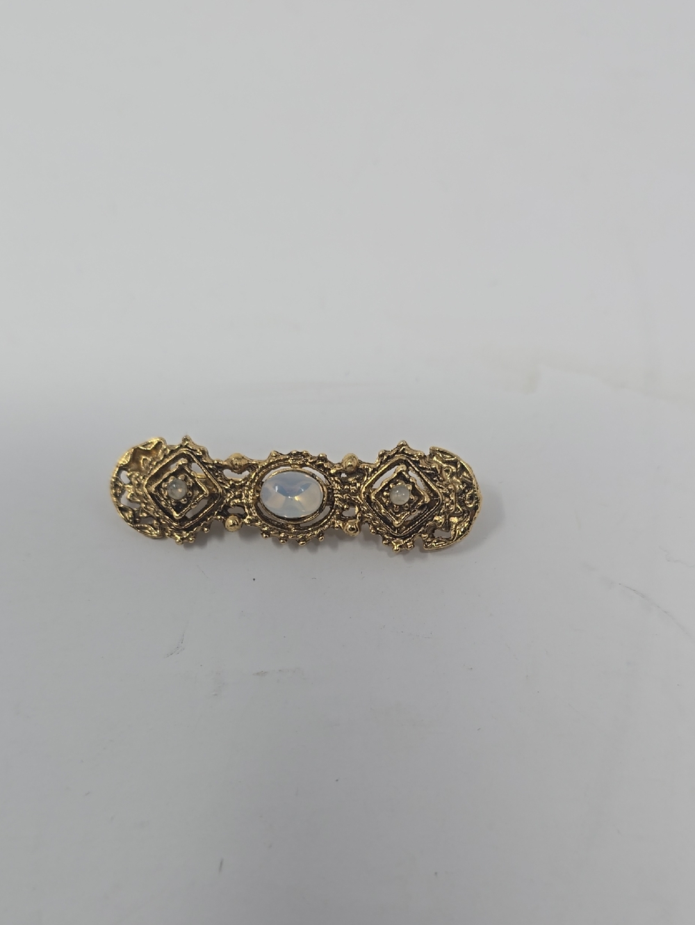Gold-Tone Baroque Brooch with Opalescent Center